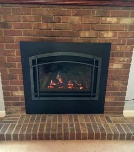 Kozy Heat Direct vent insert installed in a prefab fireplace with 4 side surround trim panel